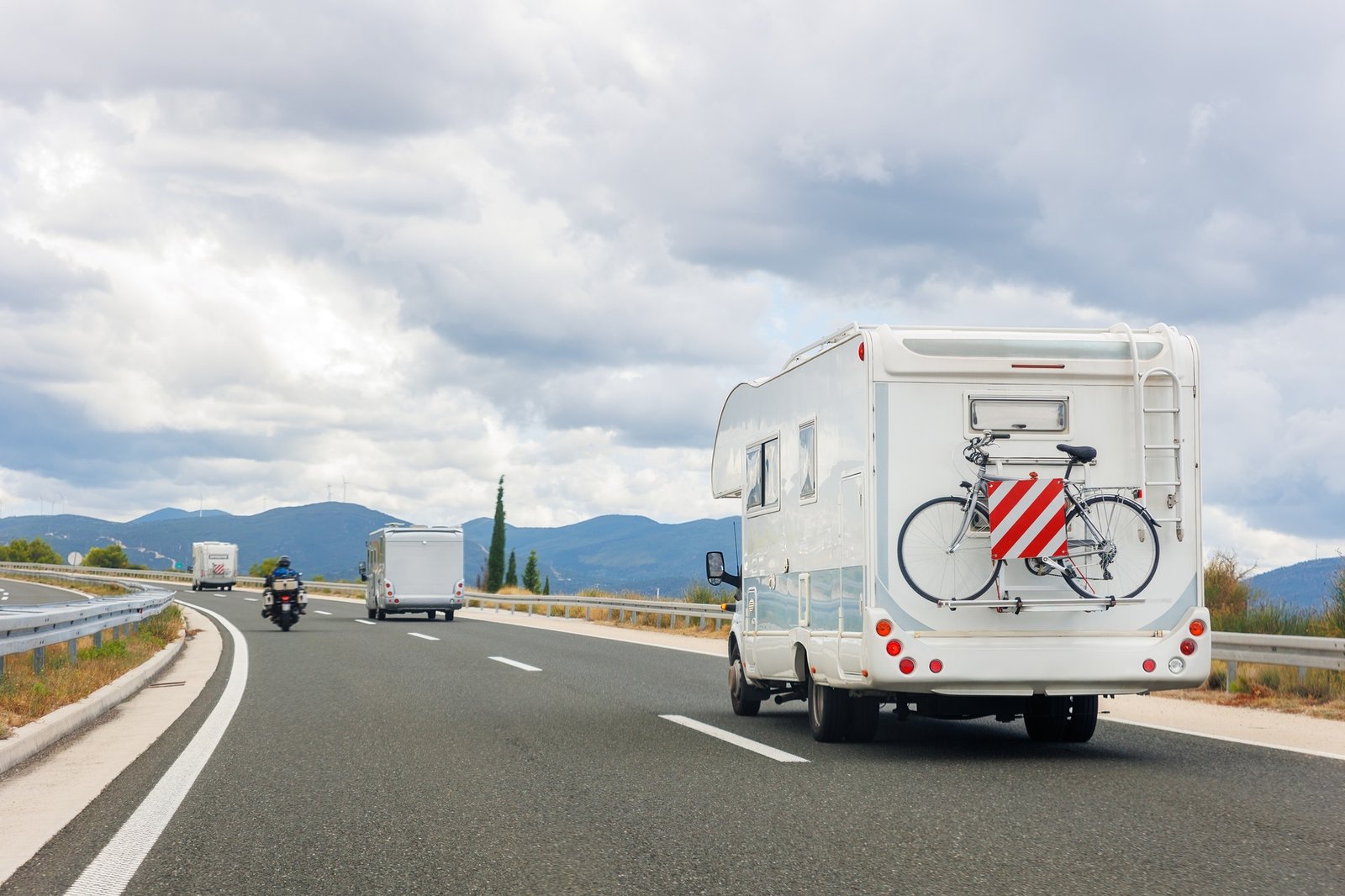 Scenic view group modern white family rv camper van vehicle drive Europe highway road alpine